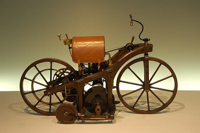 A photo showing the Daimler Reitwagen in a museum