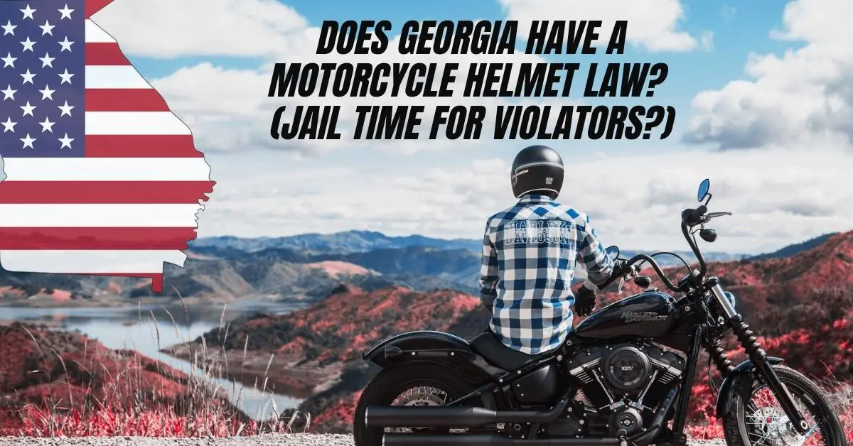 Image shows beautiful Georgia mountains and scenery in the far distance. There is a harley davidson motorcycle rider wearing a cheque shirt sitting on his stationary motorcycle and admiring the scenery.