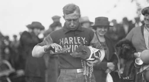 Ray Wieshaar apparently feeding the pig beer or soda with a big crowd behind him. Black and white photo from the early 19th century.