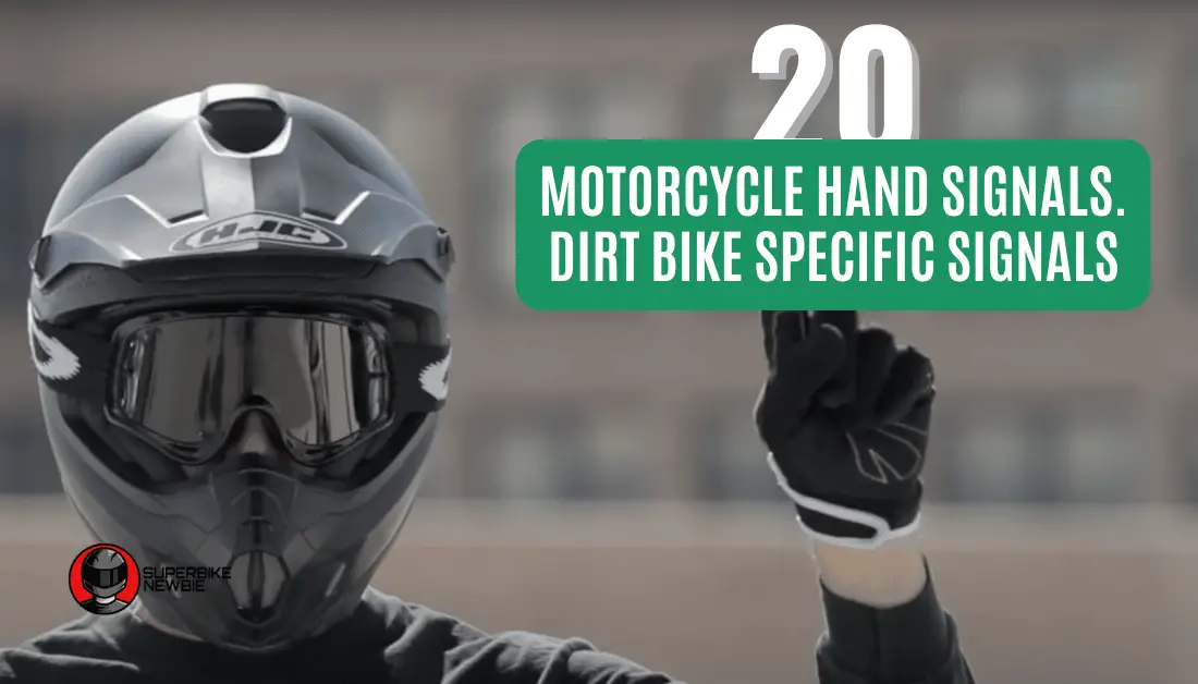 Motorcycle rider wearing a black helmet making a hand signal