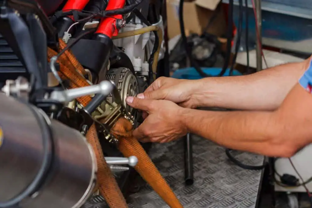 man working on a motorcycle clutch