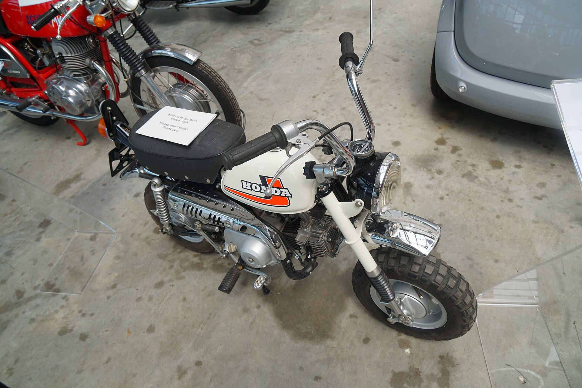 Classic white Honda Monkey minibike with HONDA tank decal on display at Motorworld Boeblingen